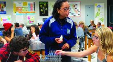 Photo of teacher and students working in the lab