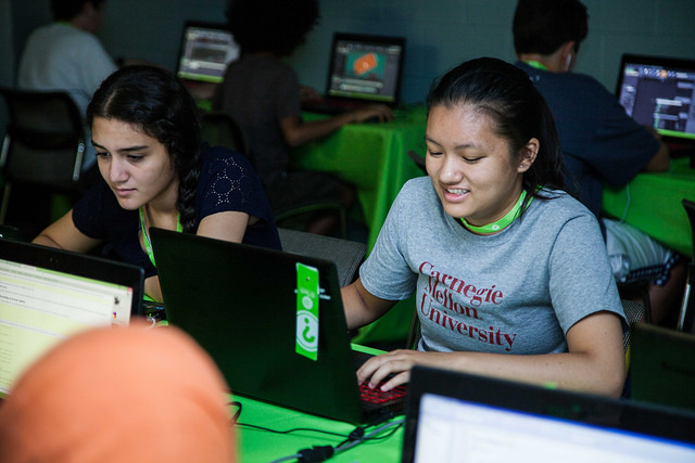 TechGirls Paricipants looking at computer