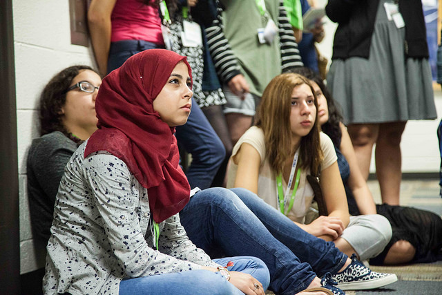 tech girls participant sitting on floor looking up