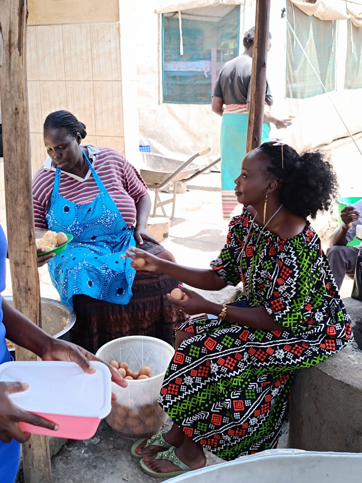 Catherine providing meals and food at the outpatient camp of the Uganda Cancer Institute