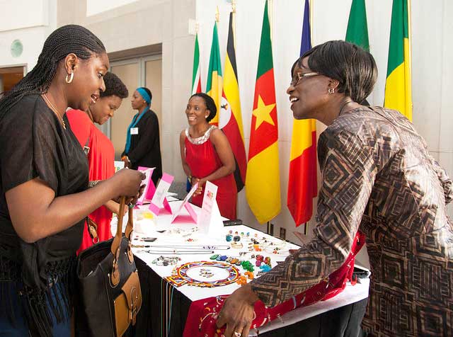 African woman shows product to another woman