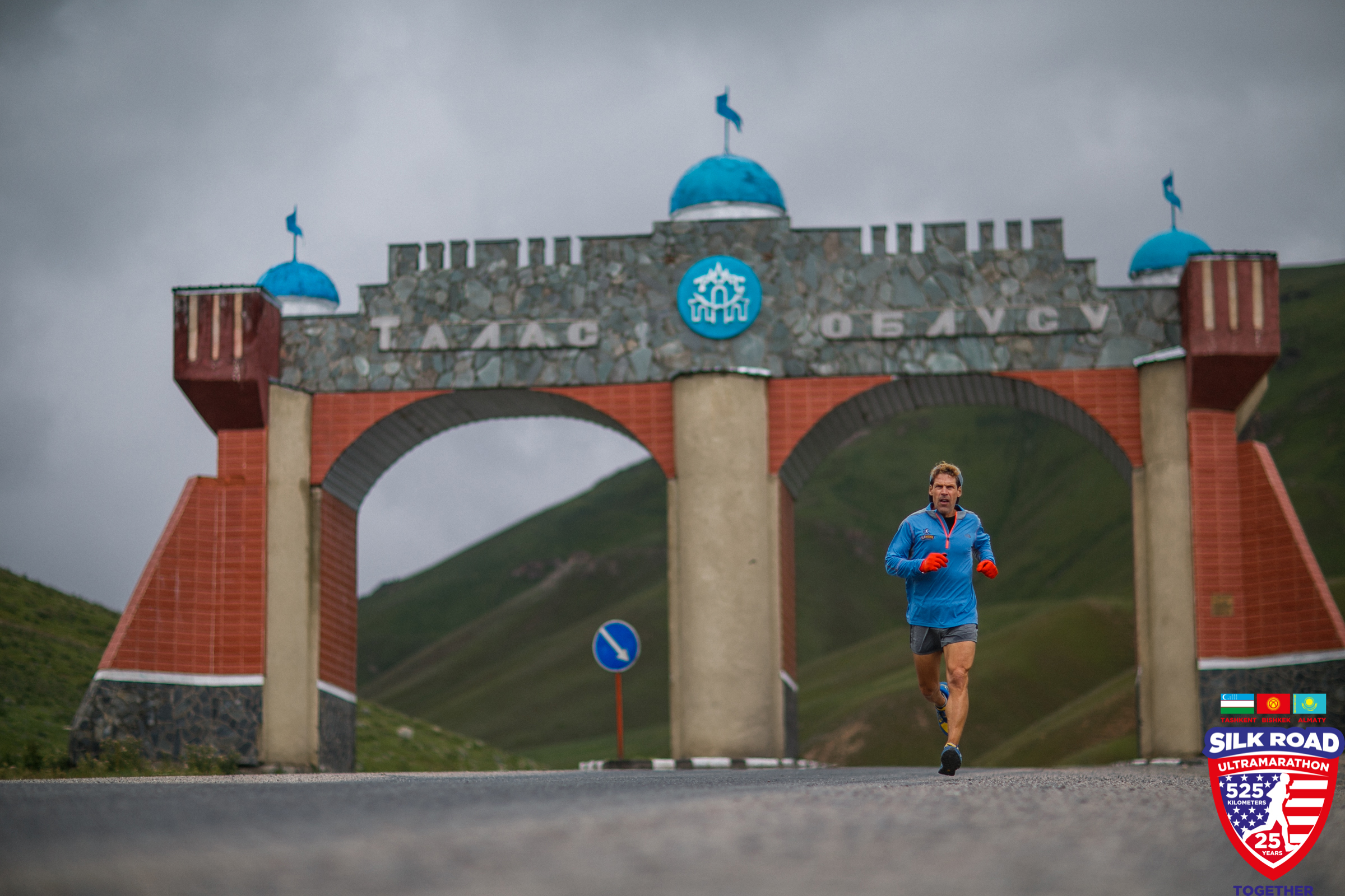 Dean running through a large archway in the Kyrgyz Republic