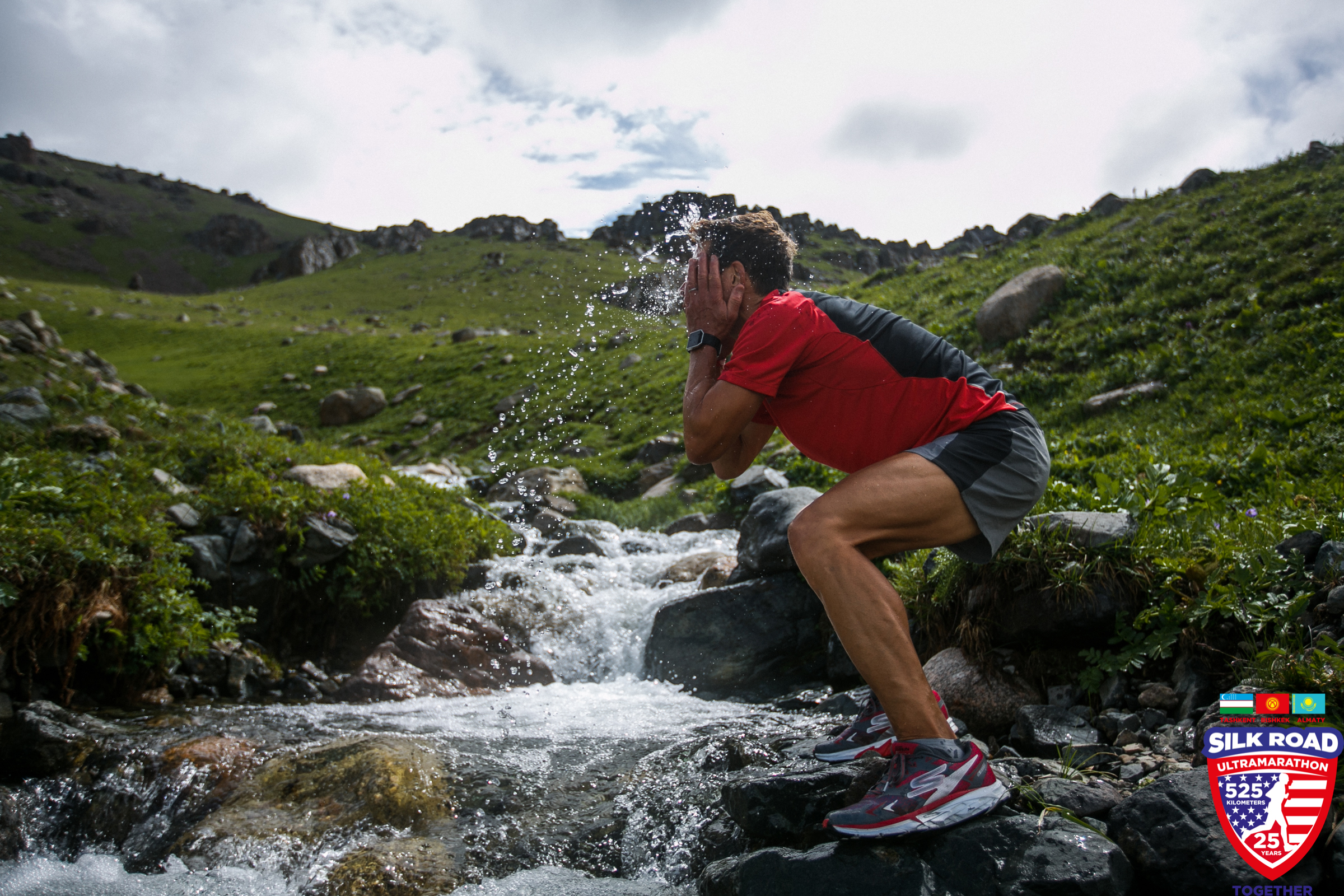 Dean cools off by splashing his face with water from a mountain stream