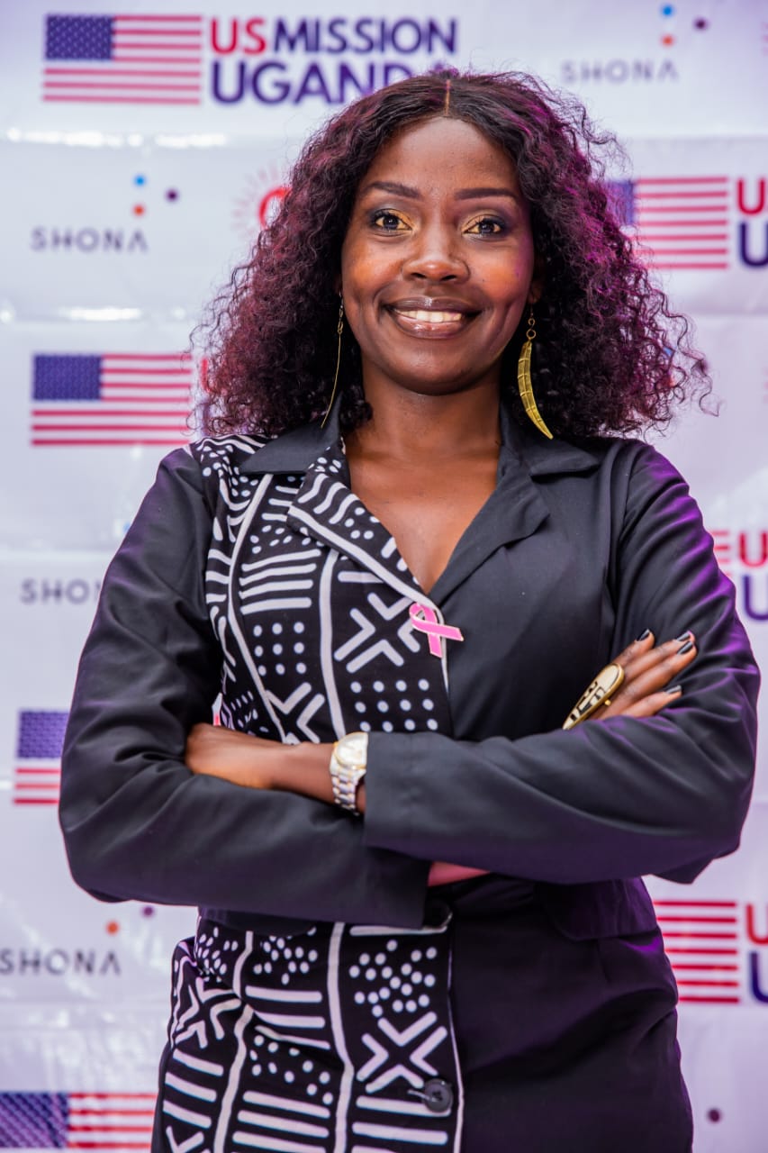 Catherine at the graduation ceremony of the AWE program, wearing one of her dress designs