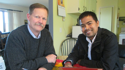 John and Chhunn pose for a photo.