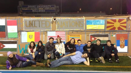 Group of students pose on the infield of the Drake University track