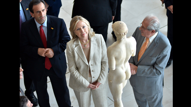 U.S. Secretary of State, Hillary Clinton, admiring the sculpture "Kritios Boy" at the Acropolis Museum.