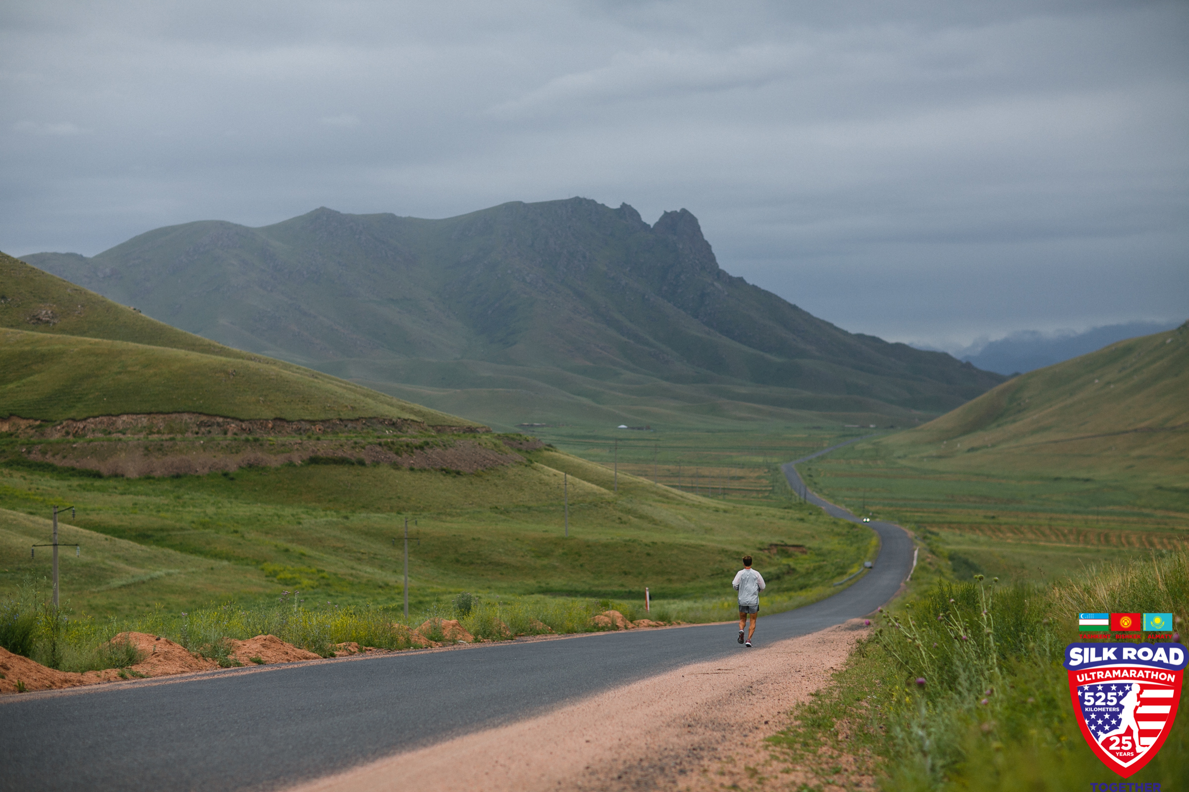 Dean running ahead against the backdrop of amazing Kyrgyz mountains