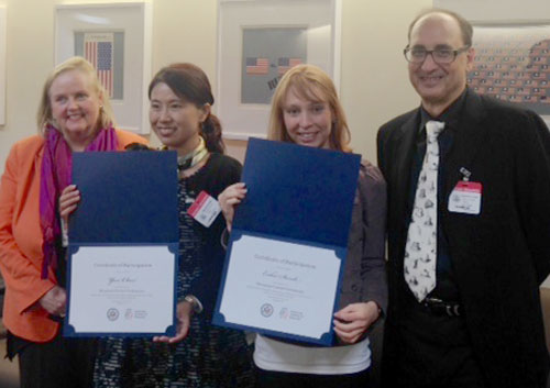 Participants pose with their certificates for completing the program