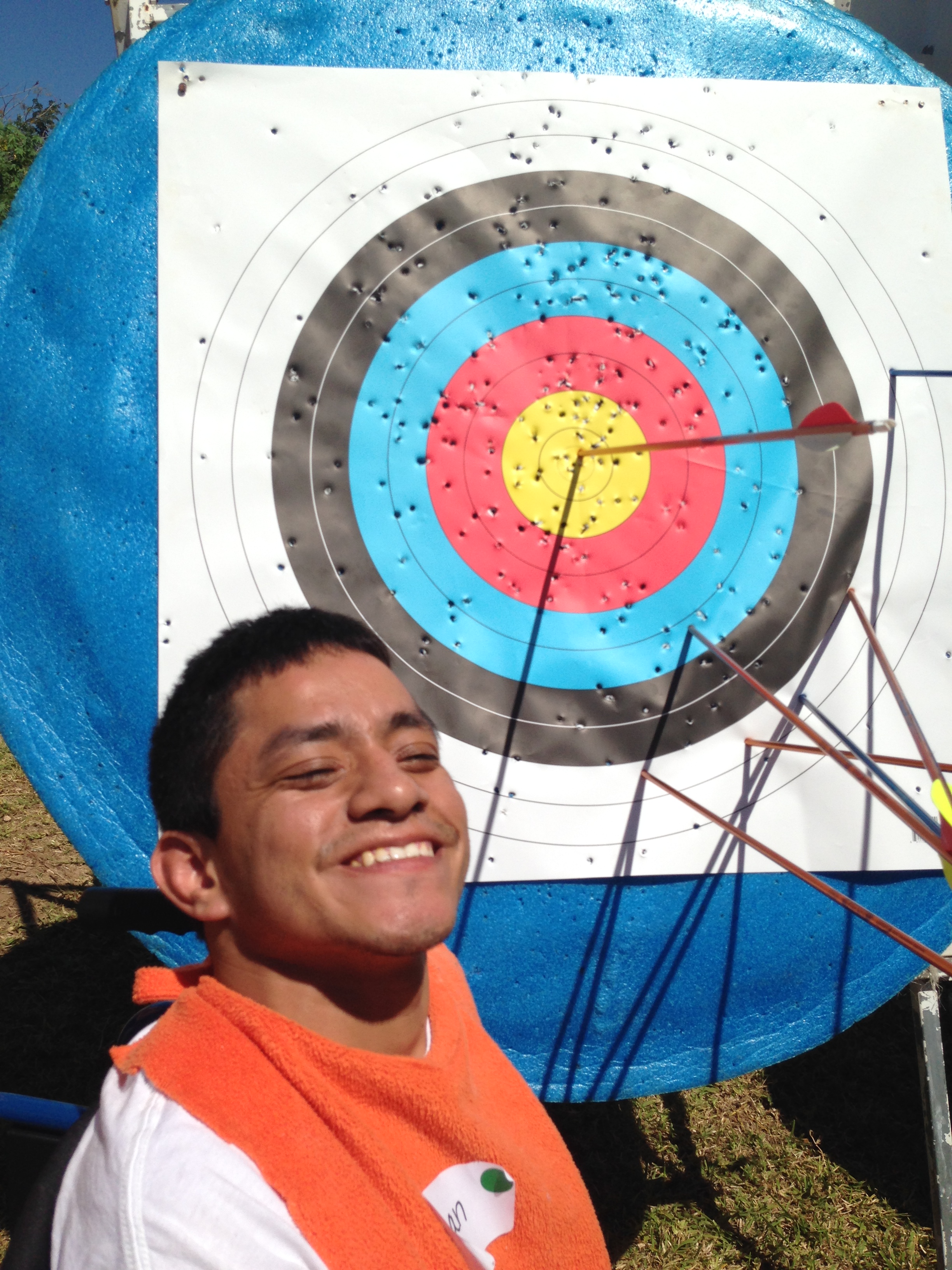 Juan poses by his first-ever bull’s-eye during an archery session