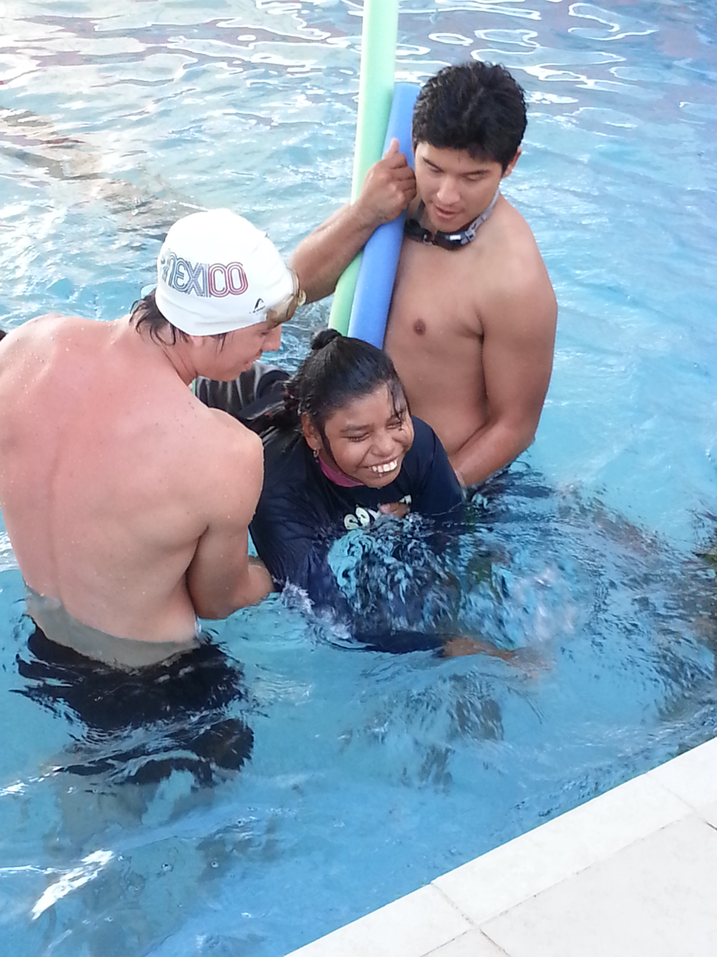 A young girl with cerebral palsy enjoys a swimming class