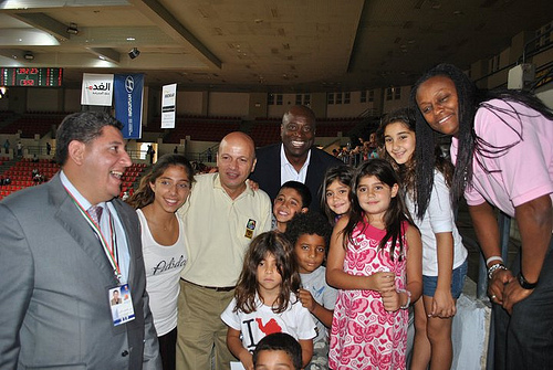 Andrea Stinson and Sam Vincent pose with young Jordanian fans.
