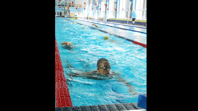 An American swimmer perfects his stroke by the end of the program.