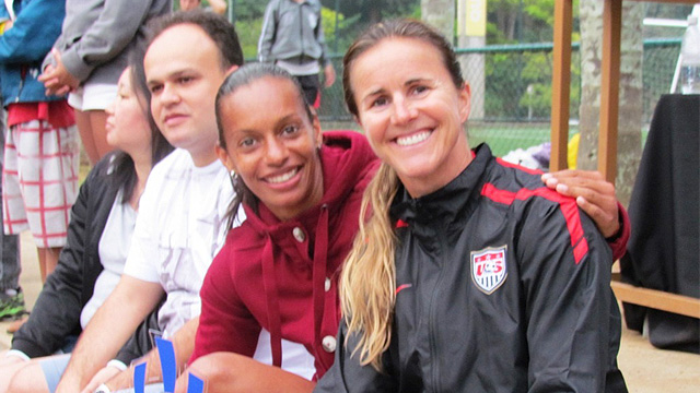 Brandi Chastain poses with Rosana dos Santos Augusto at a Soccer Festival in celebration of the positive things that come with participation in sports.