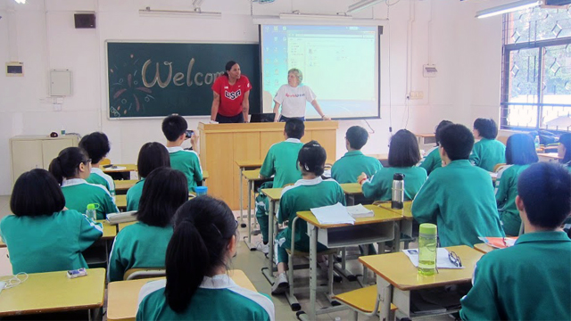 Sports Envoys Dr. Woodson Smith and Dr. Clark talk with high school students at Zhi Xin High School about disability sports culture in the United States.