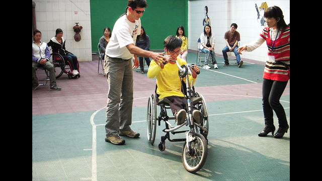 Guangzhou English Training Center (GETCH) students lead an adaptive cycling session in China.