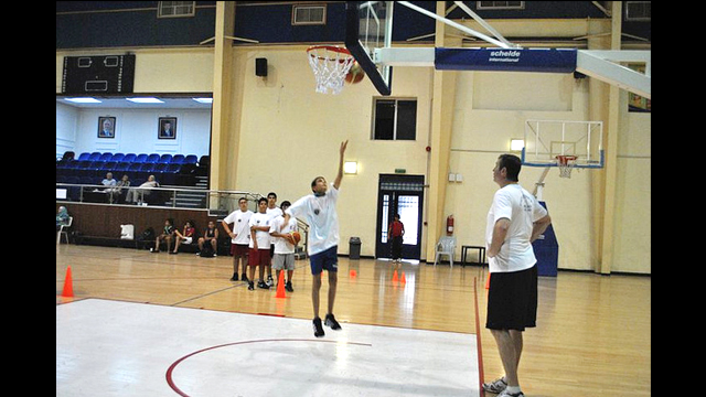 A Jordanian boy does a lay-up for Marty Conlon.