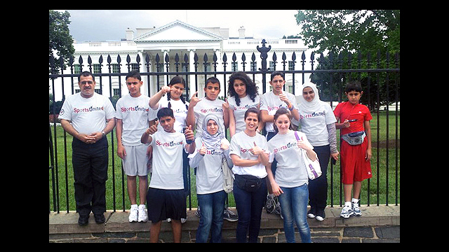 The group enjoys a tour of our nation's capital and poses in front of the White House.