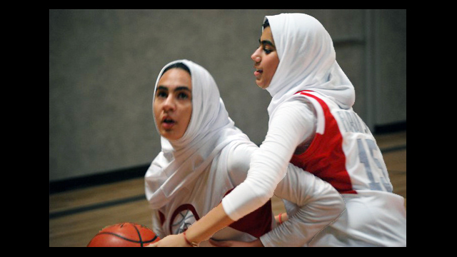 Girls use their new skills during a game of one-on-one.