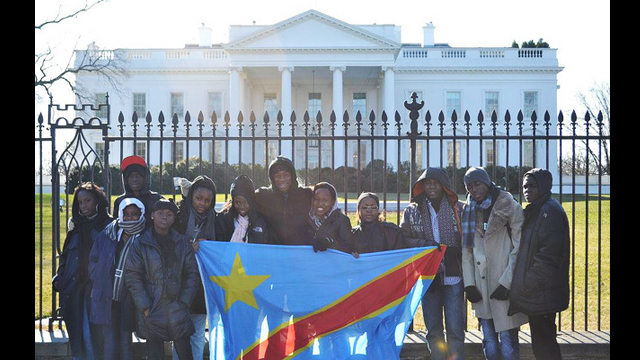 The group proudly poses with their national flag in front of the White House during their tour of the nation’s capital.