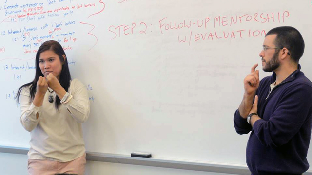 Macki Calbay, Deaf Advocacy Coordinator for De La Salle- College of St Benilde, and Davin Searls, Executive Director of Discovering Deaf Worlds, lead a discussion on action plan development using the logic model.