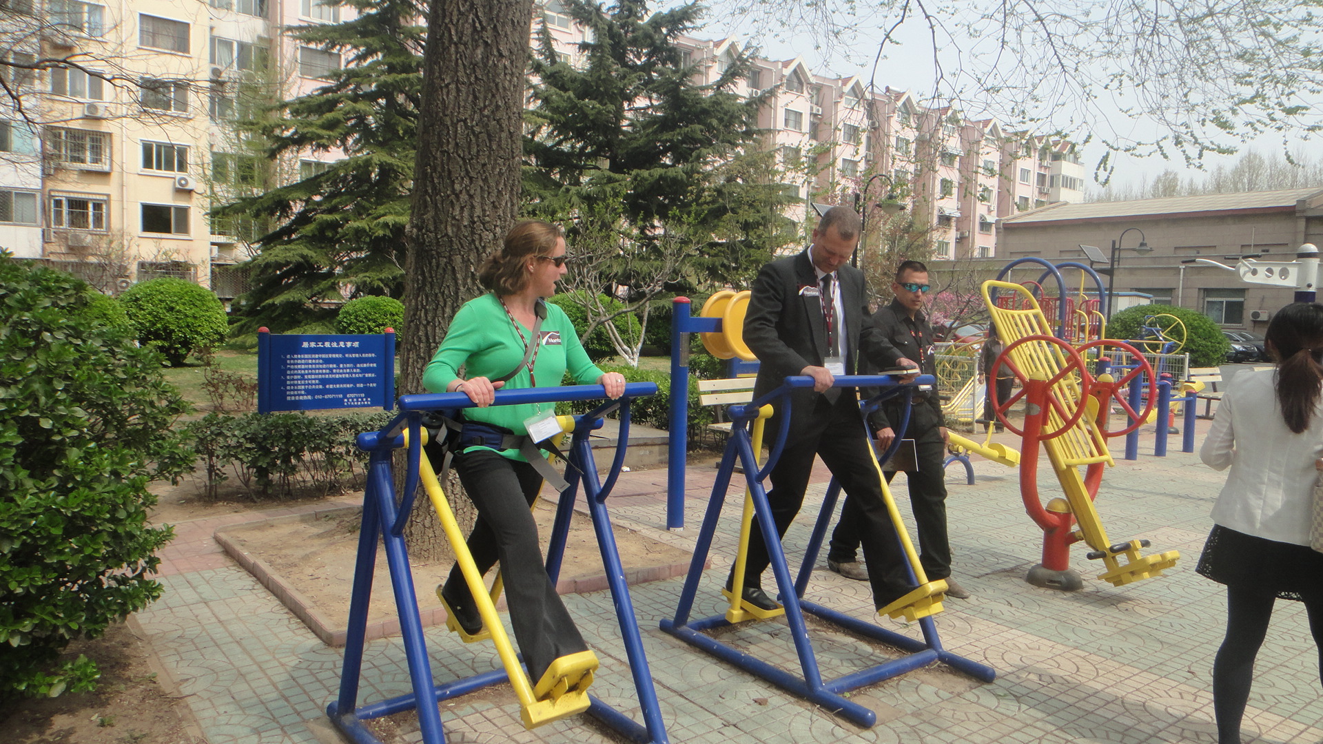 The group enjoys recreational equipment at a local Chinese park.