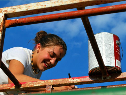 An A-SMYLE student helps improve a local playground as a community service project.