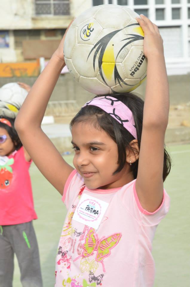 Another young soccer player awaits instruction during a clinic