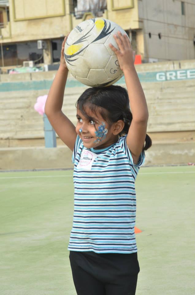 One young participant in face paint eagerly awaits instructions during a drill