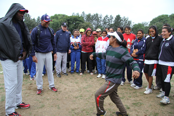 A young Indian woman demonstrates her dancing skills to peers and the envoys.