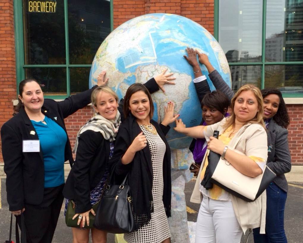 Group of young women touching large globe