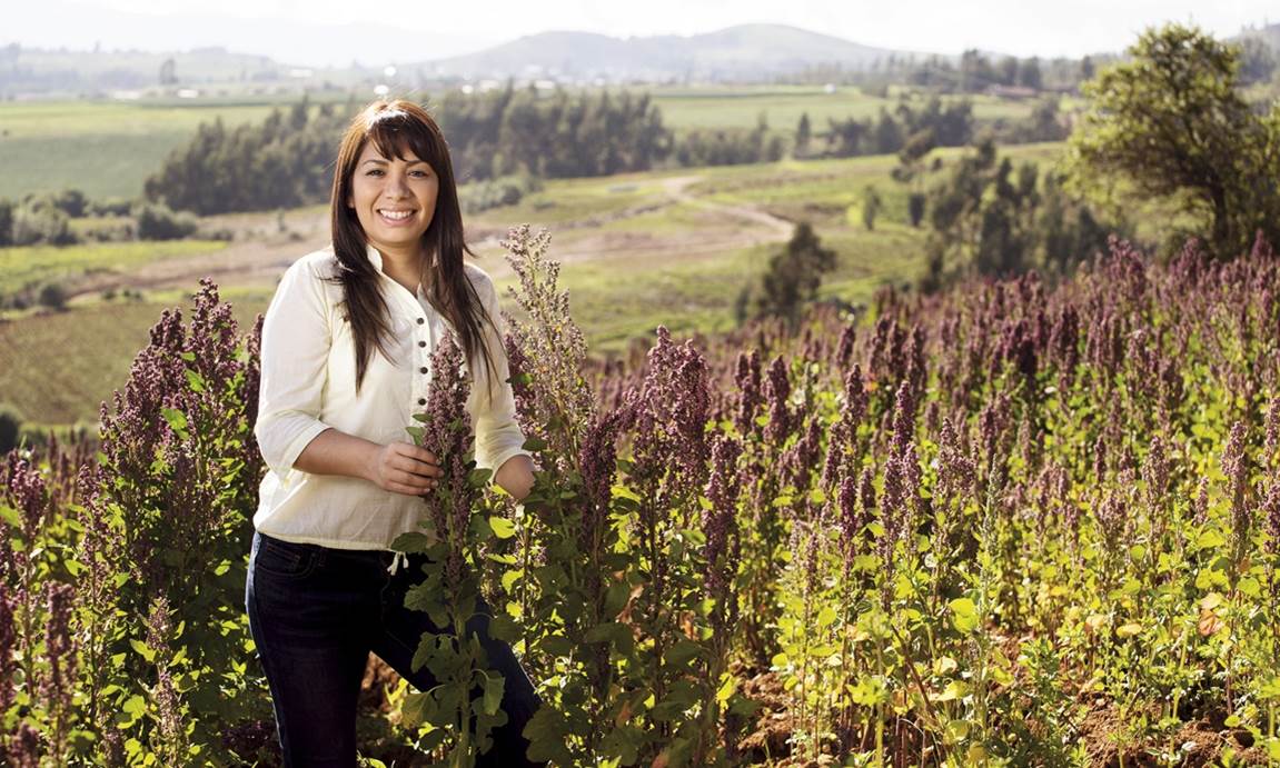 Young woman standing in a field of plants