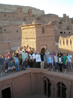 NSLI-Y scholars pose in front of a tower at Aït Benhaddou.