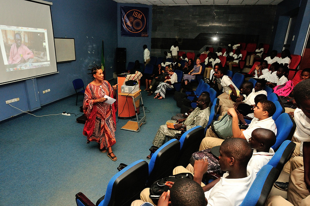 “Next Stop: Brooklyn/Dakar” (2012) between ImagiNationAfrika in Senegal and the Brooklyn Children’s Museum. An auditorium of students participates in a conference call to connect with their peers in Brooklyn.