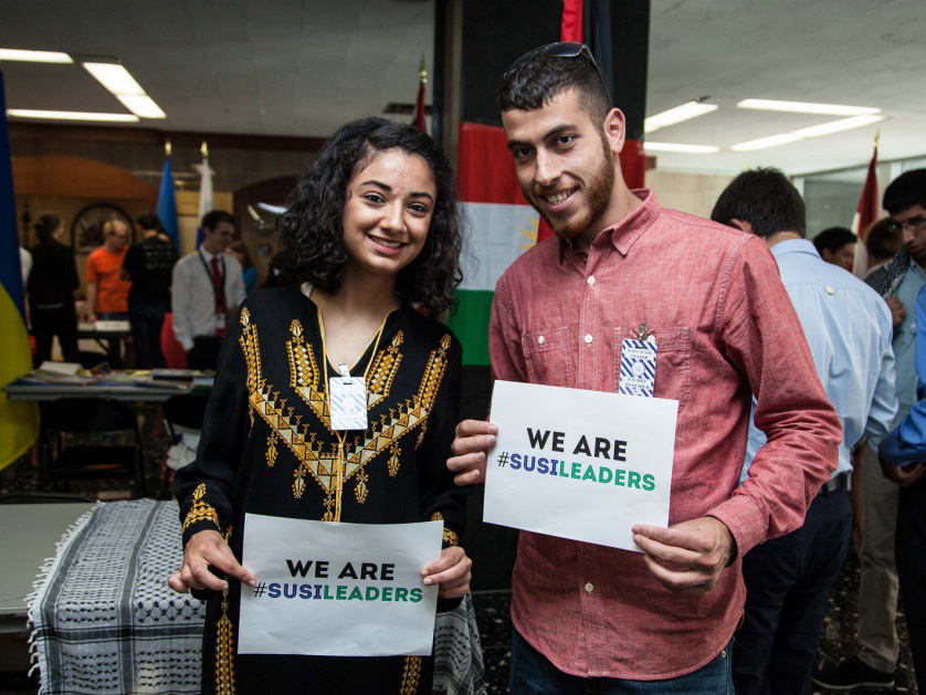 Male and female participant holding signs that say "We are SUSI leaders"