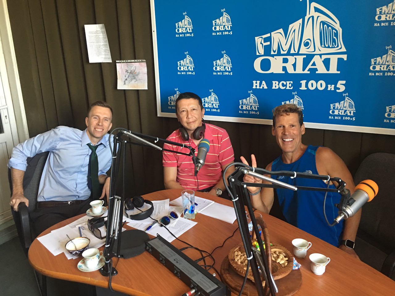 Dean behind the talk show microphones with the radio staff