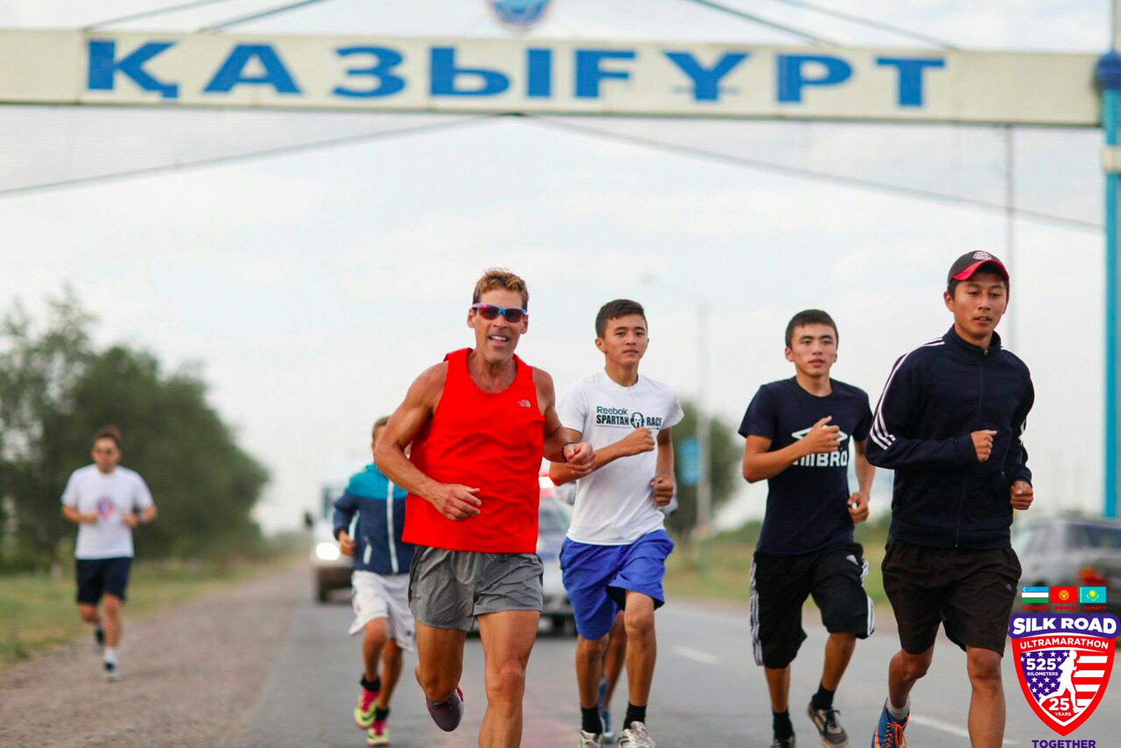Dean runs past the town banner
