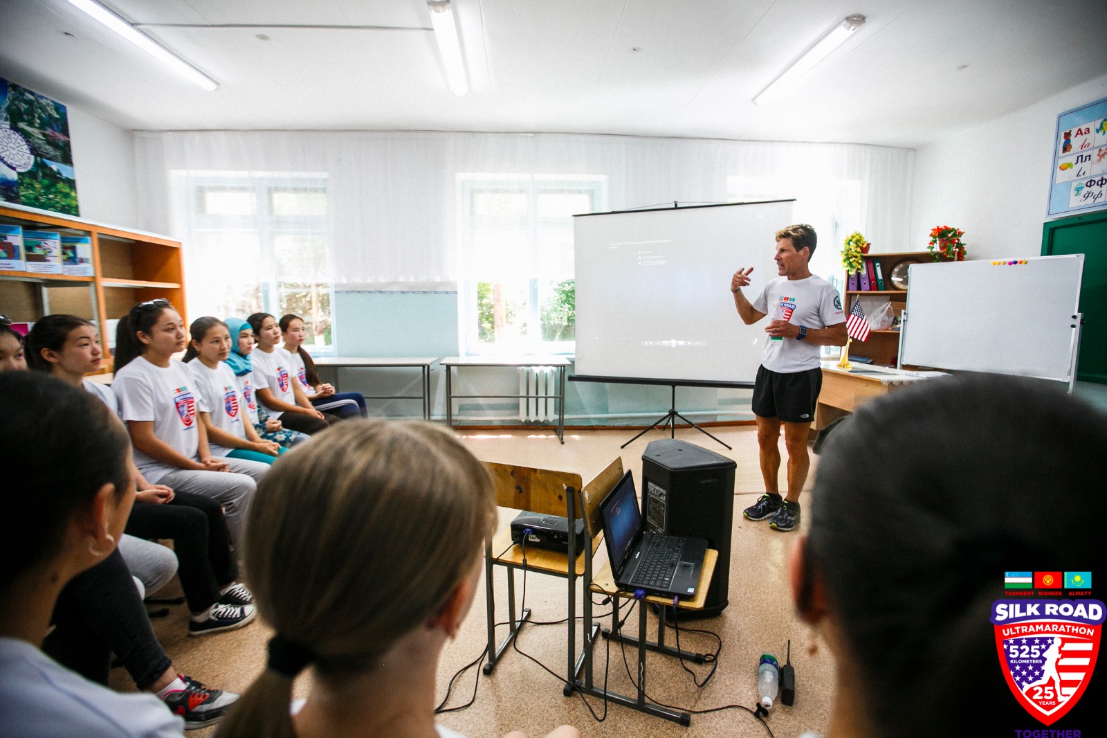 Man standing in front of classroom giving a presentation to youth