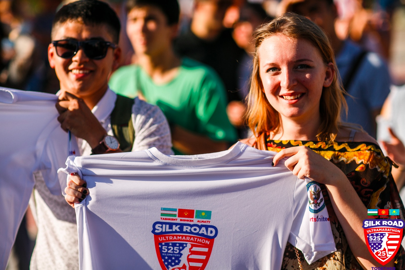 Teens holding up Silk Road Ultramarathon shirt