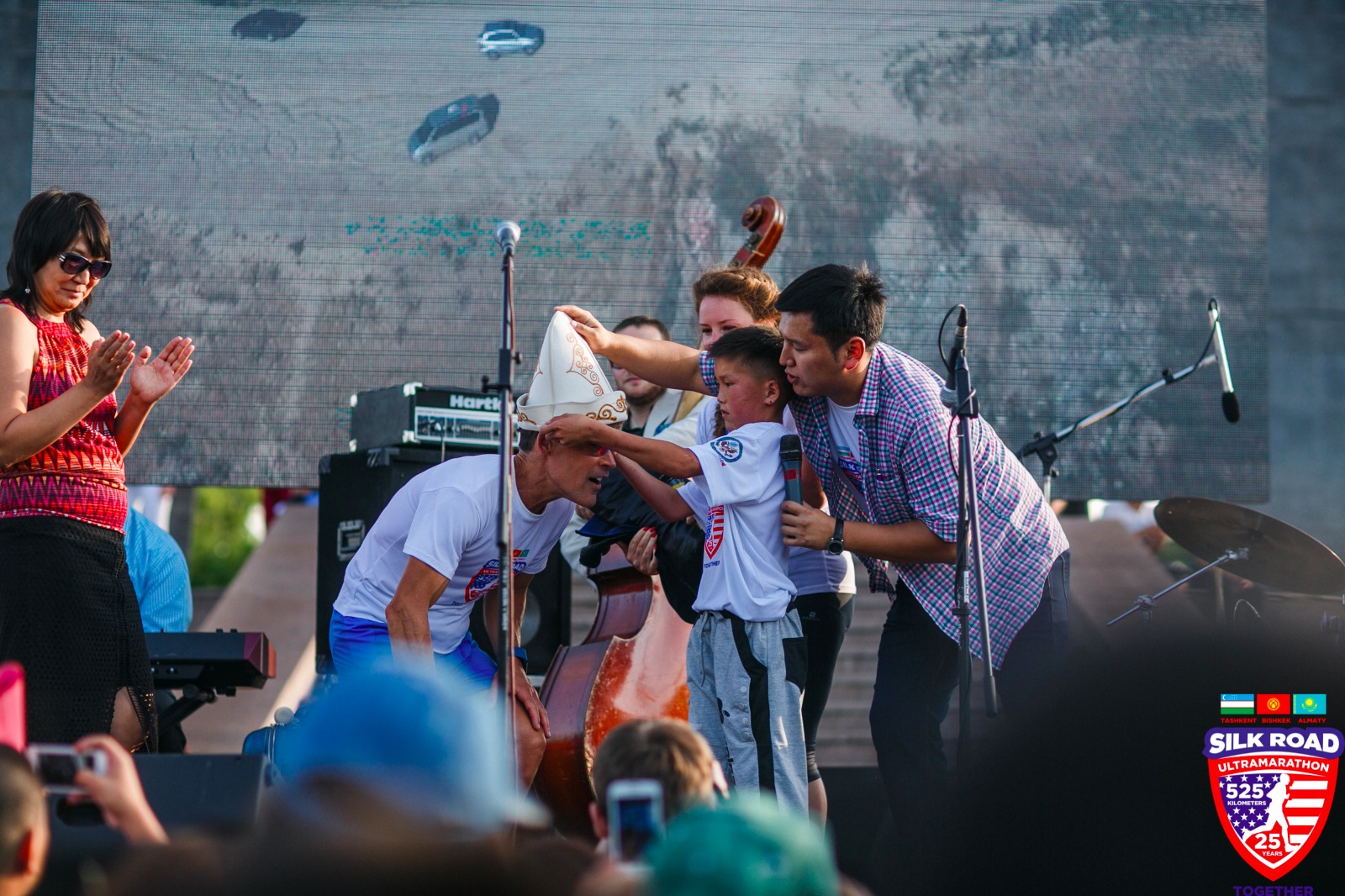 Dean receiving Kyrgyz hat at a concert