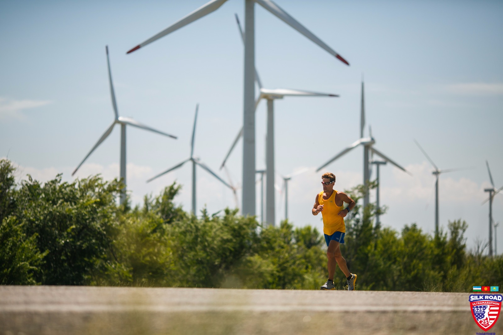 Dean running with wind turbines in the background