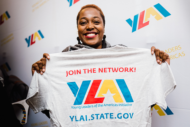 Woman holding up YLAI t-shirt