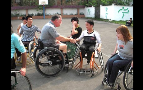 Participants from Mobility International USA and Guangzhou English Training Center (GETCH) students work together on the court.