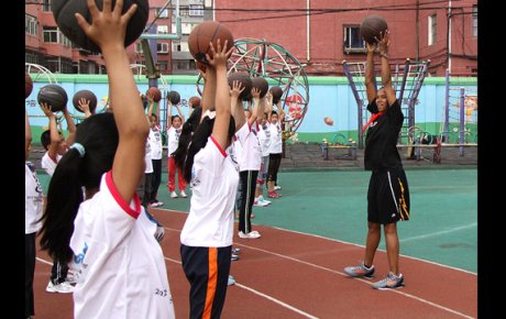 Kiesha Brown teaches ball handling to the girls from Shenhe Migrant Workers Elementary School in China.