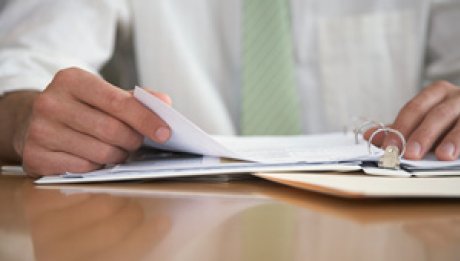 Image of a person flipping through pages in a book. Image of a person flipping through pages in a book.
