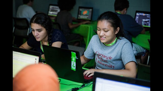 TechGirls Paricipants looking at computer