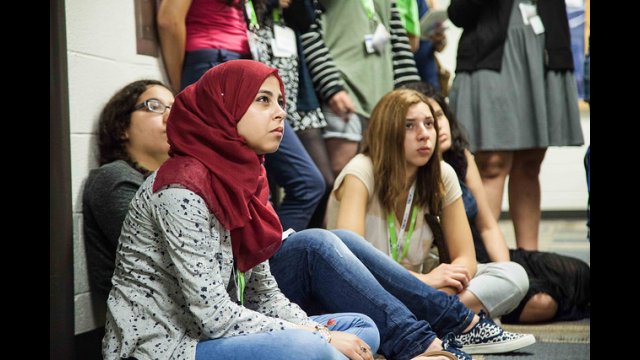 tech girls participant sitting on floor looking up