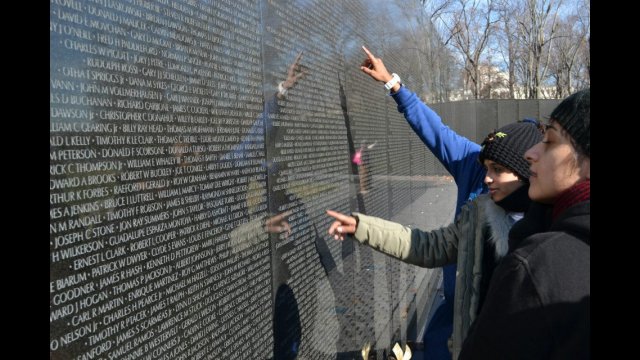 During their tour of Washington, D.C., the group takes time to absorb the significance of the Vietnam War Monument.