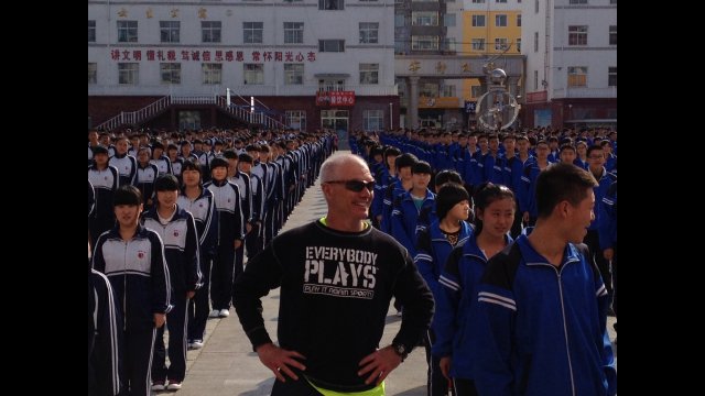 An American participant leads the Chinese youth in some exercise activities. 