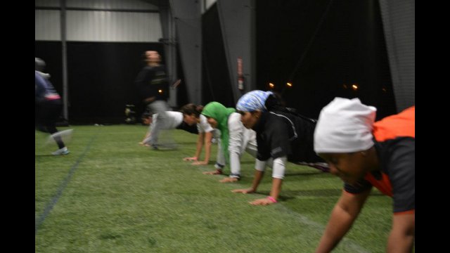 The volleyball coaches from the Gulf Nations stay strong throughout a challenging workout.